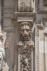 Scary lion head as decorative figure at facade of the Cathedral of Milano, Milan, Italy, closeup, details