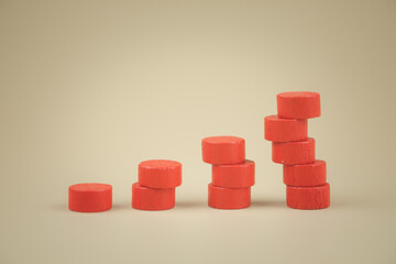 Stack of wood red toy blocks like a staircase or graph symbolizing sales growth.