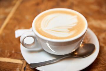 A cup of coffee or Latte with heart pattern in a white cup