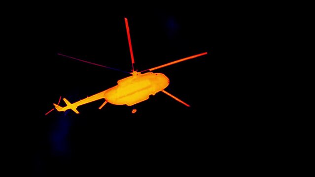 Helicopter flying in the night sky (black background). Slow motion. Analog of infrared scanning. Super slow motion 1000 fps