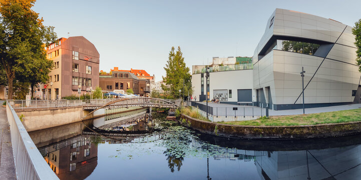 24 July 2022, Osnabruck, Germany: Cityscape view of Hase river stream with buildings and old bridges