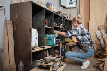 Contemporary Carpenter Working, Portrait of modern carpenter making wood furniture while working in joinery lit by sunlight with factory background on small business concept, copy space