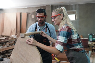 Contemporary Carpenter Working, Portrait of modern carpenter making wood furniture while working in joinery lit by sunlight with factory background on small business concept, copy space