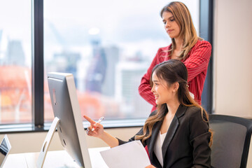 Senior team leader of group of startup business co-worker working in office look at laptop computer help explanation unclear assignment to new comer employee