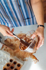 Woman the chef prepares chocolate sweets. Homemade delicious sugar dessert. Healthy food
