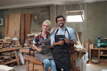 Contemporary Carpenter Working, Portrait of modern carpenter making wood furniture while working in joinery lit by sunlight with factory background on small business concept, copy space