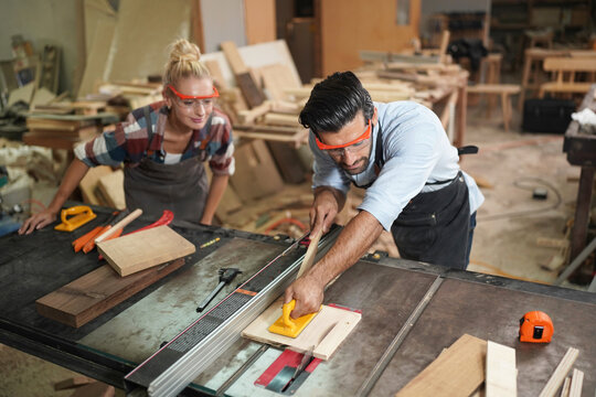 Contemporary Carpenter Working, Portrait Of Modern Carpenter Making Wood Furniture While Working In Joinery Lit By Sunlight With Factory Background On Small Business Concept, Copy Space