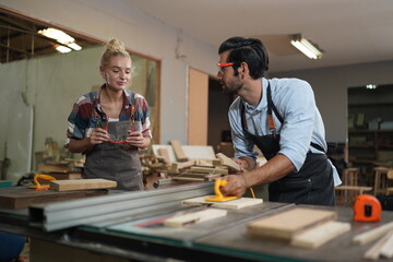 Contemporary Carpenter Working, Portrait of modern carpenter making wood furniture while working in joinery lit by sunlight with factory background on small business concept, copy space
