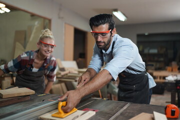Contemporary Carpenter Working, Portrait of modern carpenter making wood furniture while working in joinery lit by sunlight with factory background on small business concept, copy space
