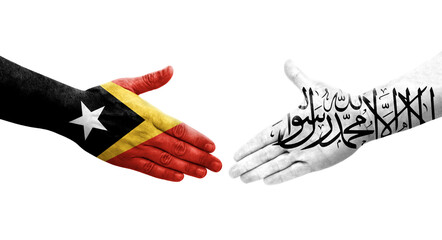 Obraz premium Handshake between Afghanistan and Timor Leste flags painted on hands, isolated transparent image.