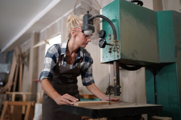 Contemporary Carpenter Working, Portrait of modern carpenter making wood furniture while working in joinery lit by sunlight with factory background on small business concept, copy space