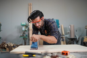 Contemporary Carpenter Working, Portrait of modern carpenter making wood furniture while working in...
