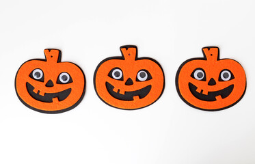 Top view of Halloween decoration with pumpkins on white background. felt monsters toys