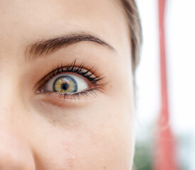 Cute look into the camera. Woman's eye close-up