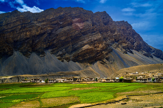 Landscape with mountains and sky. India, Himachal Pradesh, Spiti Valley, Losar village, farmhouses amongst barley fields.