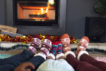 Low section of african american family wearing socks and sitting in living room - Powered by Adobe