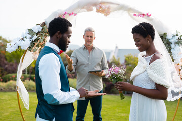 Happy african american couple with ring during wedding