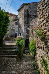 View on the narrow but beautiful cobblestone street of the medieval village of Lanas, in the south of France (Ardeche)