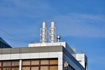 Gas boiler equipment on the roof of the building on an autumn day
