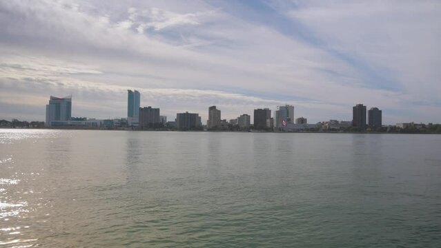 Windsor, Ontario Canada skyline with Detroit River recorded from Detroit, Michigan with video panning left to right.