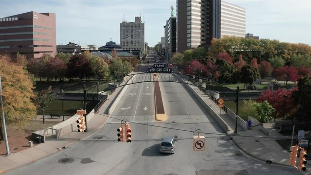 Vehicle City sign in downtown Flint, Michigan with drone video moving up.