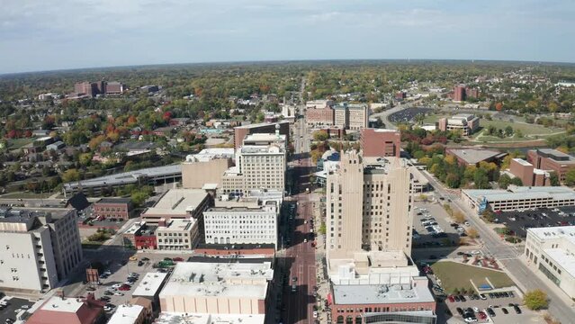 Flint, Michigan skyline wide shot up high with drone video moving forward.