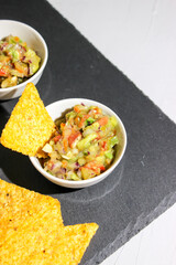 Mexican guacamole sauce with nachos chips
