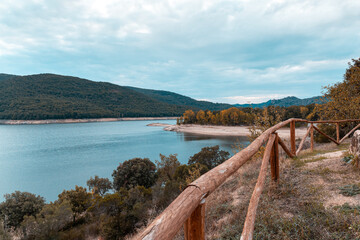 Partial view of Lago di Gusana near Gavoi at sunset in autumn with dramatic clouds