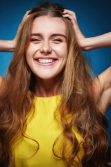 happy woman with strong healthy curly hair