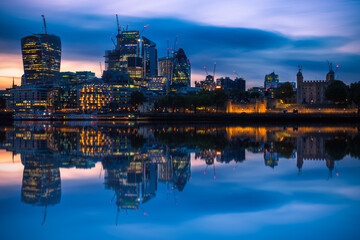 London cityscape with reflection from river Thames during sunset