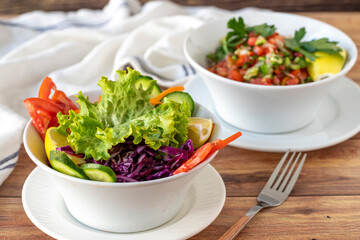 Assortment of salads on wood floor. Salads made with vegetables. close up