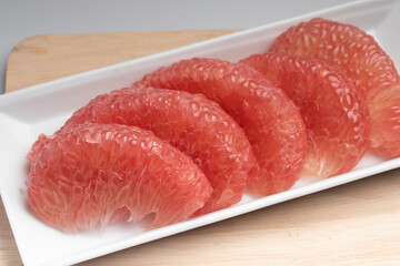 Red Pomelo or Grapefruit on a wooden floor