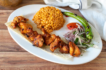 Grilled chicken skewers on wood background. Turkish foods. close up