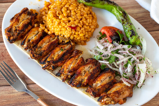 Grilled chicken wing skewers on wood background. Turkish foods. close up