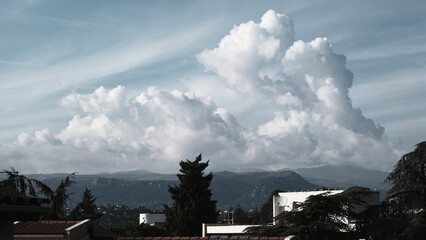 High cumulus clouds over the mountains, panorama, landscape, beautiful sky with cloud, heaven on the summer day, dramatic cloudscape, peaceful environment, skyscape over the mountain.