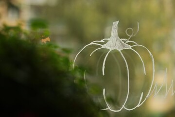 Pumpkin drawing with a sharpie on a window glass