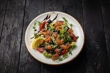 delicious salad in a plate on a dark table
