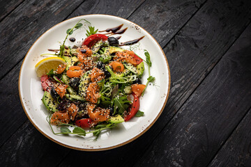 delicious salad in a plate on a dark table
