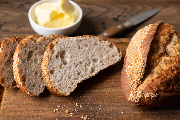 Artisan bread and butter on wooden board. Healthy white leavened bread