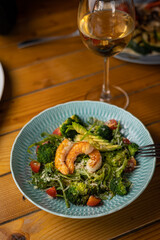 tasty salad in a plate on a brown table
