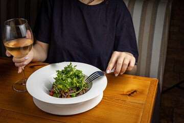 tasty salad in a plate on a brown table
