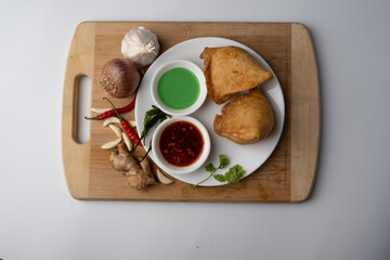 Veg Samosa - is a crispy and spicy Indian triangle shape snack which has crisp outer layer of maida filling of mashed potato, peas and spices