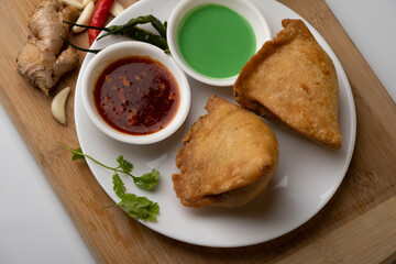Veg Samosa - is a crispy and spicy Indian triangle shape snack which has crisp outer layer of maida filling of mashed potato, peas and spices