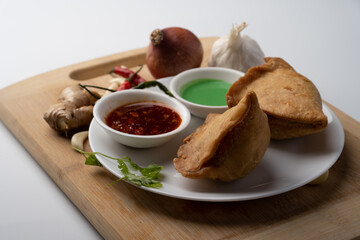 Veg Samosa - is a crispy and spicy Indian triangle shape snack which has crisp outer layer of maida filling of mashed potato, peas and spices