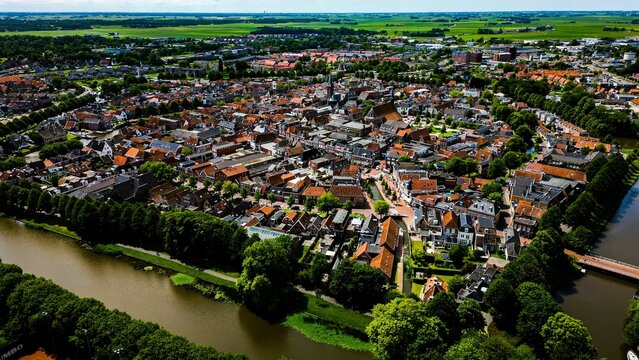 Aerial shot of the beautiful Dokkum city surrounded by a river during daytime