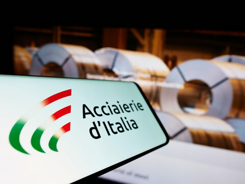 Stuttgart, Germany - 10-01-2022: Smartphone with logo of Italian steel company Acciaierie d&rsquo;Italia S.p.A. on screen in front of business website. Focus on center of phone display.