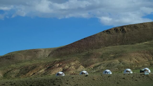 Domed residential buildings in the mountains. Round houses with a spherical roof for panoramic view of beautiful natural landscapes. Construction stage. Eco touristic glamping camps.