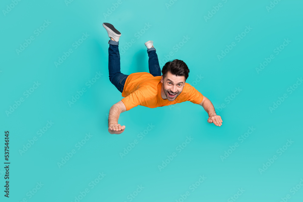 Poster Full body photo of crazy guy playing air gliding flying isolated on cyan color background