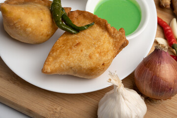 Veg Samosa - is a crispy and spicy Indian triangle shape snack which has crisp outer layer of maida filling of mashed potato, peas and spices