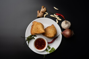 Veg Samosa - is a crispy and spicy Indian triangle shape snack which has crisp outer layer of maida filling of mashed potato, peas and spices